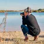 woman-crouching-doing-landscape-photography-at-lak-2022-06-20-22-48-09-utc-scaled.jpg