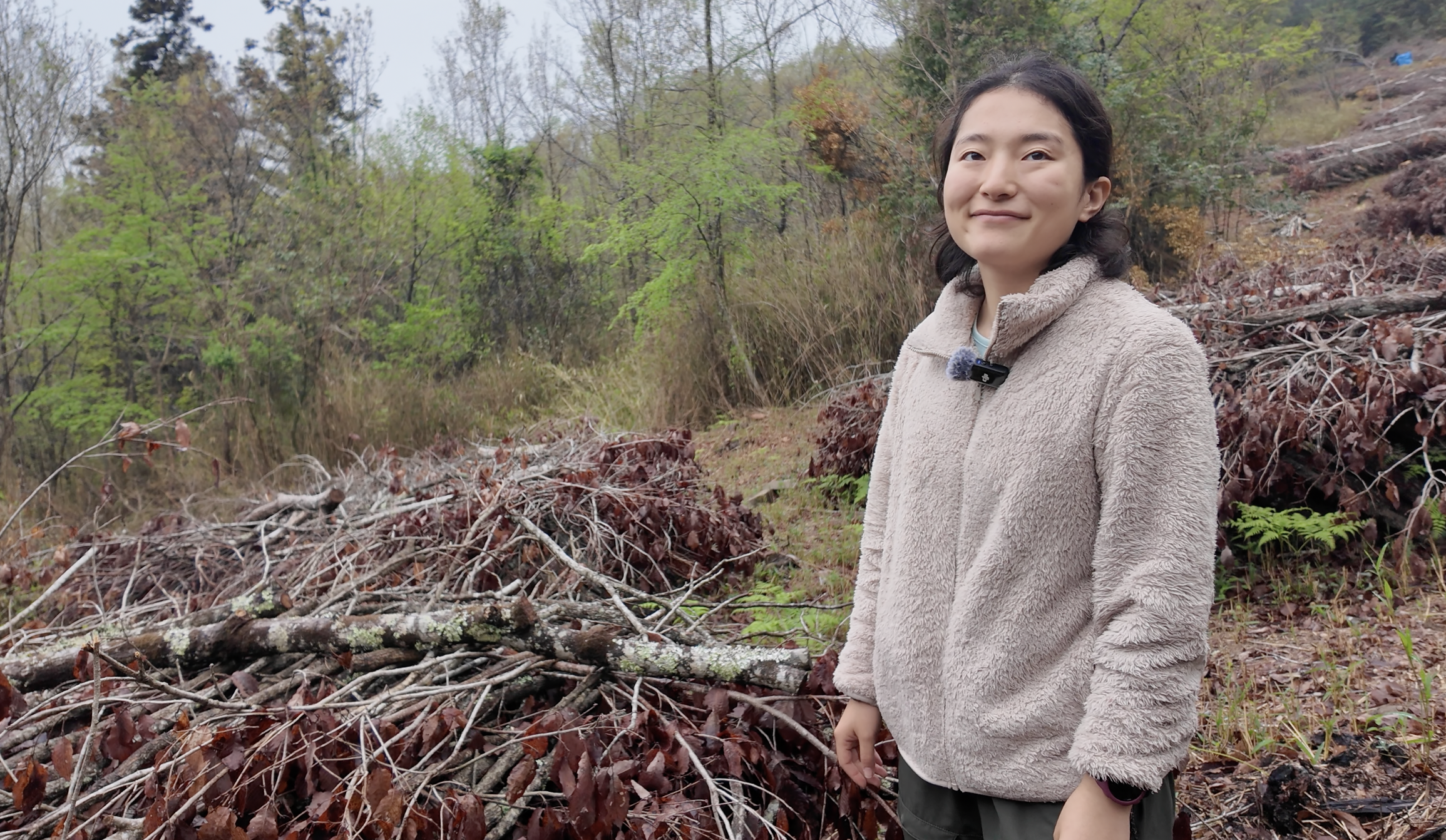 Portrait of Aki standing outdoors in a wooded area on Japan's Kunisaki Peninsula.